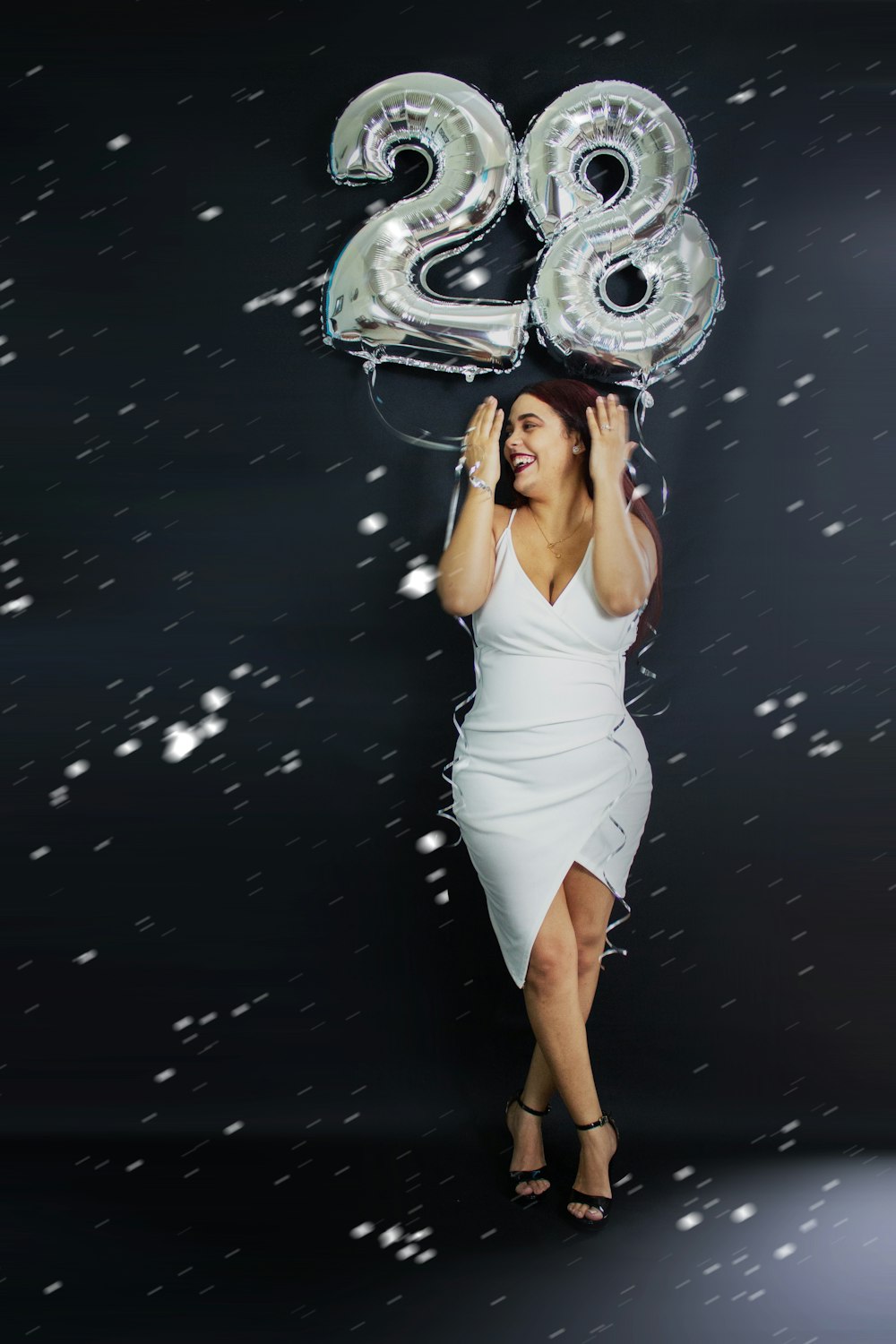 woman in white tank top and white skirt standing on water