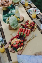 a wooden table topped with lots of fruit