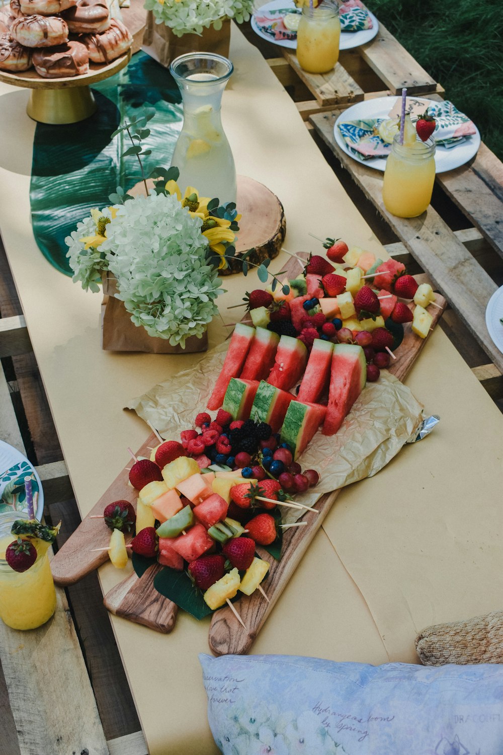 a wooden table topped with lots of fruit