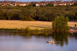 A serene morning scene of a bass fisherman casting his line into a calm ranch pond.