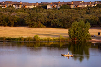 A serene early morning on Lake Erie with a fishing boat casting lines into calm waters.