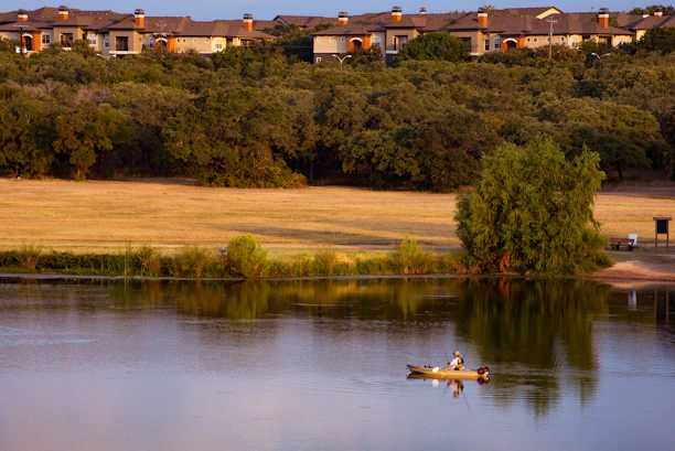 A serene early morning on Lake Erie with a fishing boat casting lines into calm waters.