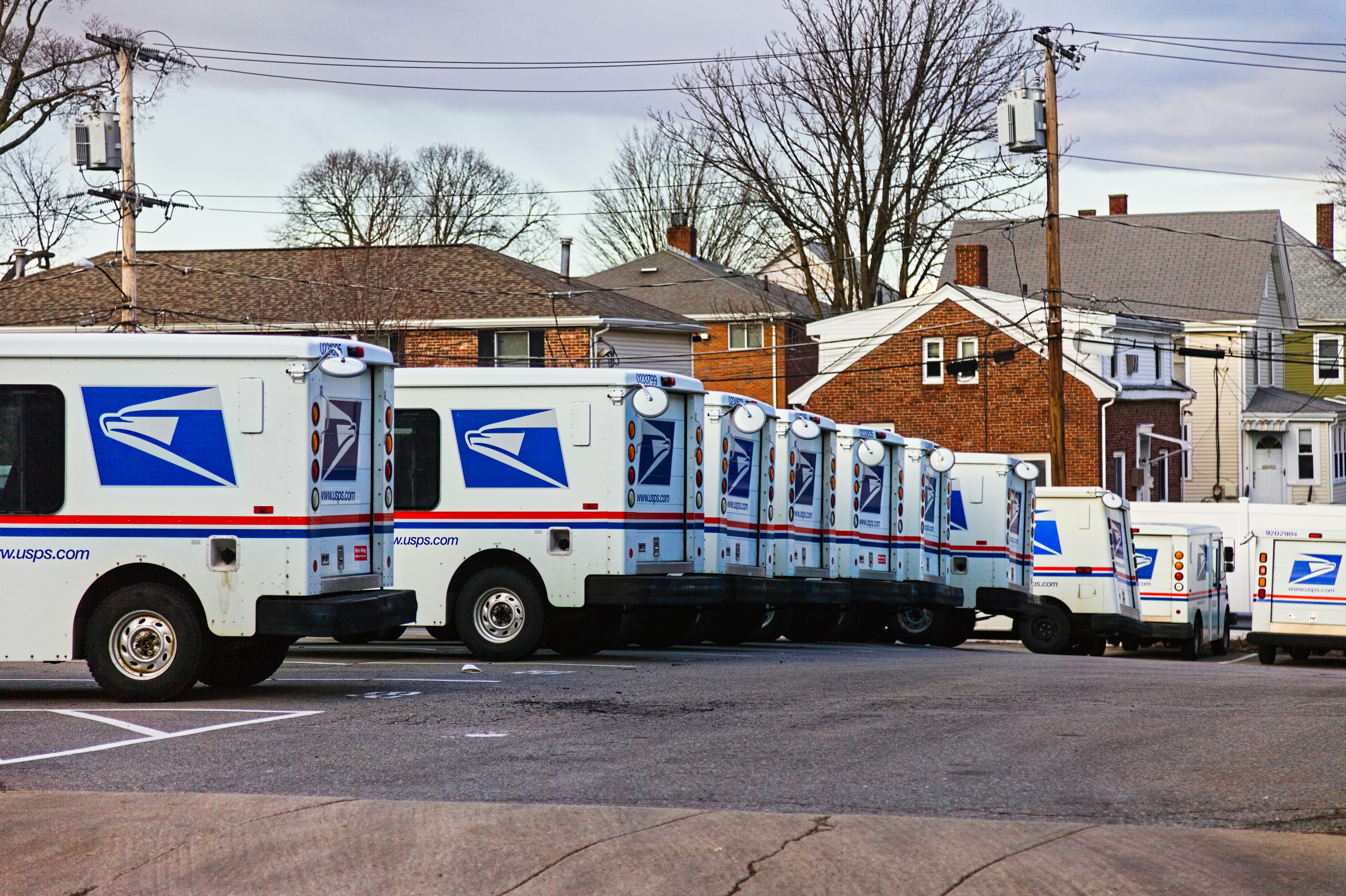 United States Postal Service mail vans lined up at the Waltham, Massachusetts mail handling facility this winter. I previously incorrectly identified these vehicles as Grumman LLVs; this was pointed out to me several months after posting this image. There are two LLVs in this image; one at the end of the line of vehicles facing to the left, and one in the back with square taillights. The majority of these vehicles are Ford FFVs, a more modern delivery vehicle.