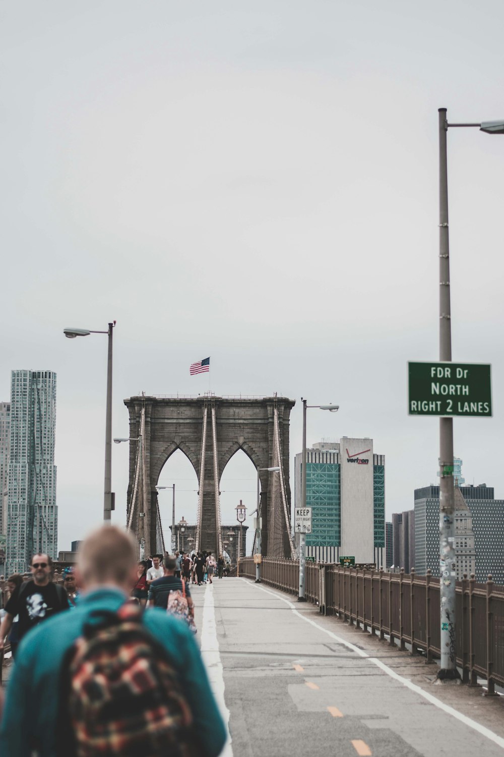 people walking on bridge during daytime