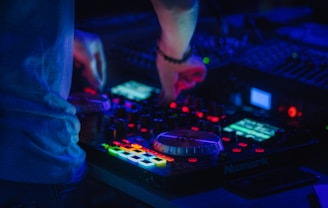 person playing audio mixer with lights
