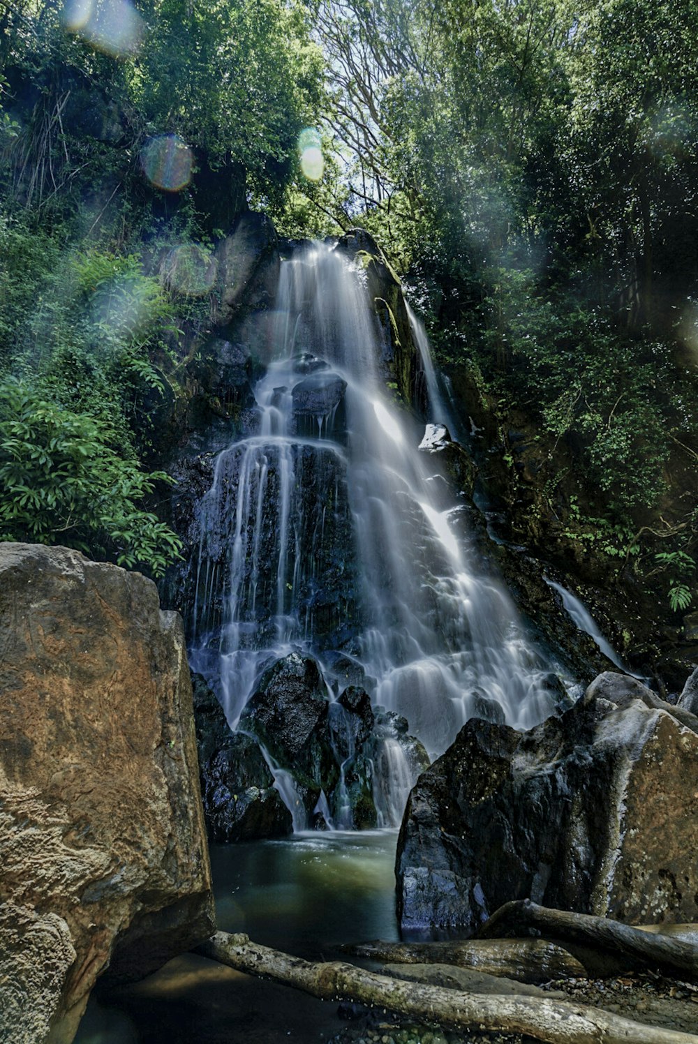 water falls on brown rocky mountain