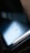 A close-up view of a smartphone's reflective surface, displaying the Xiaomi logo, CE certification, and 5G capabilities with a soft gradient of blue and black tones creating a sleek and modern appearance.