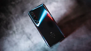 Close-up of a sleek smartphone with neon blue highlights on a dark background