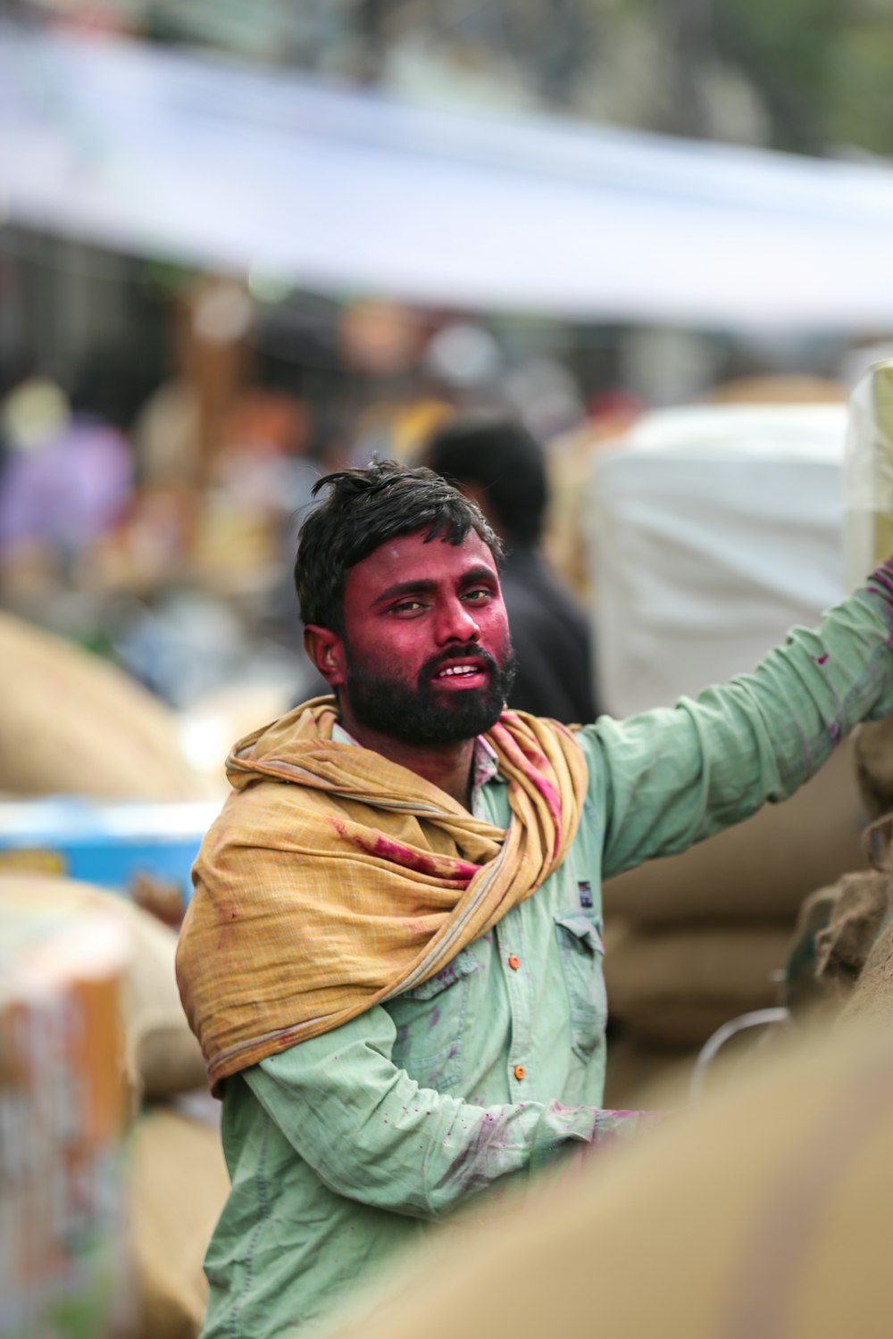 man in yellow scarf and green jacket