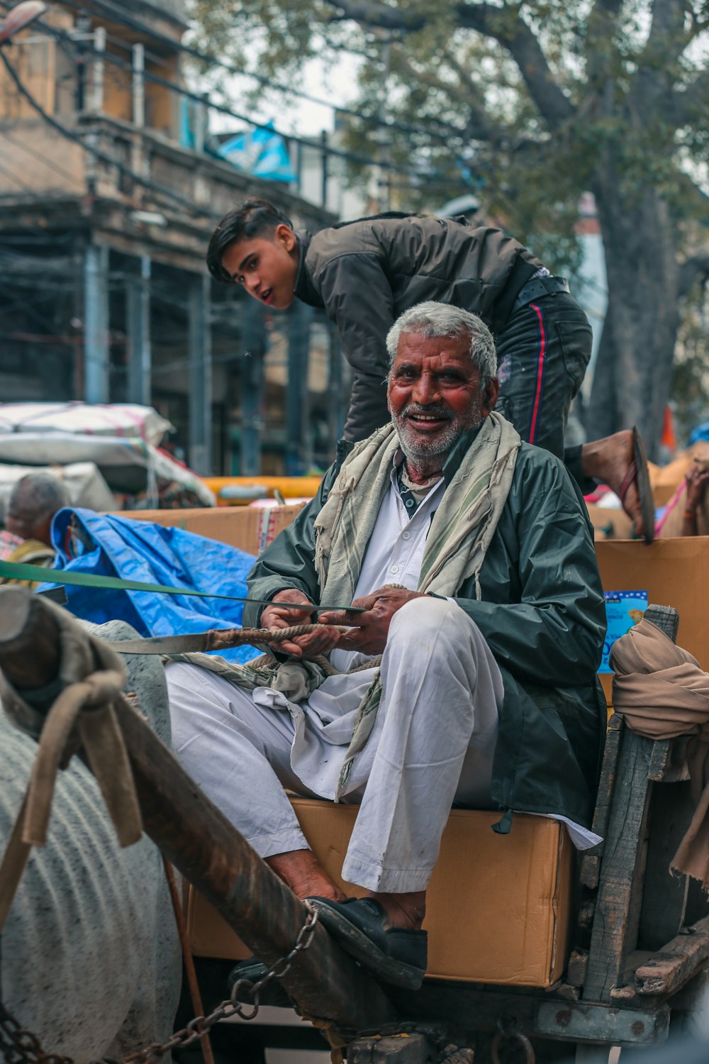 man in white thobe sitting on brown wooden chair