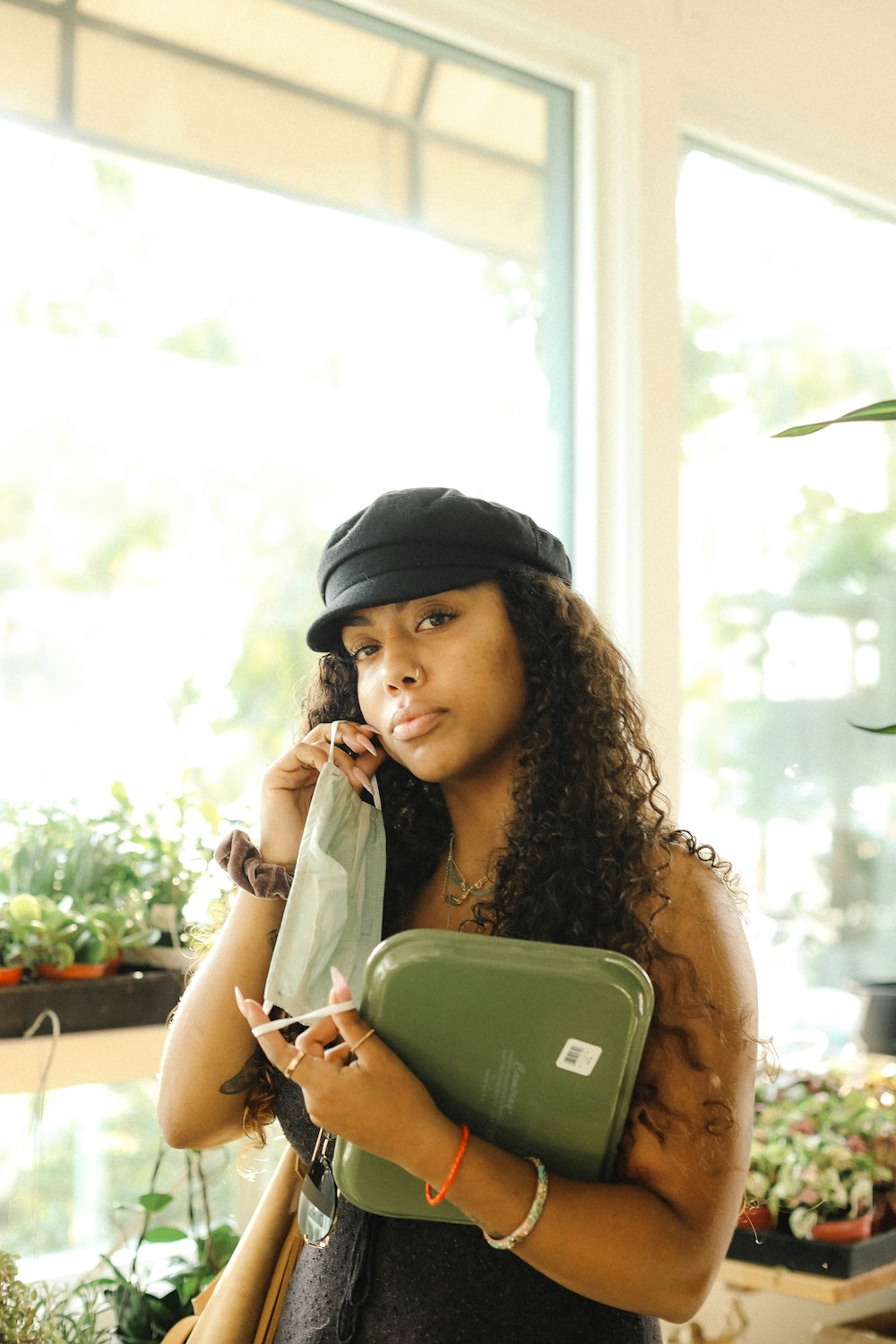 woman in white shirt wearing black cap