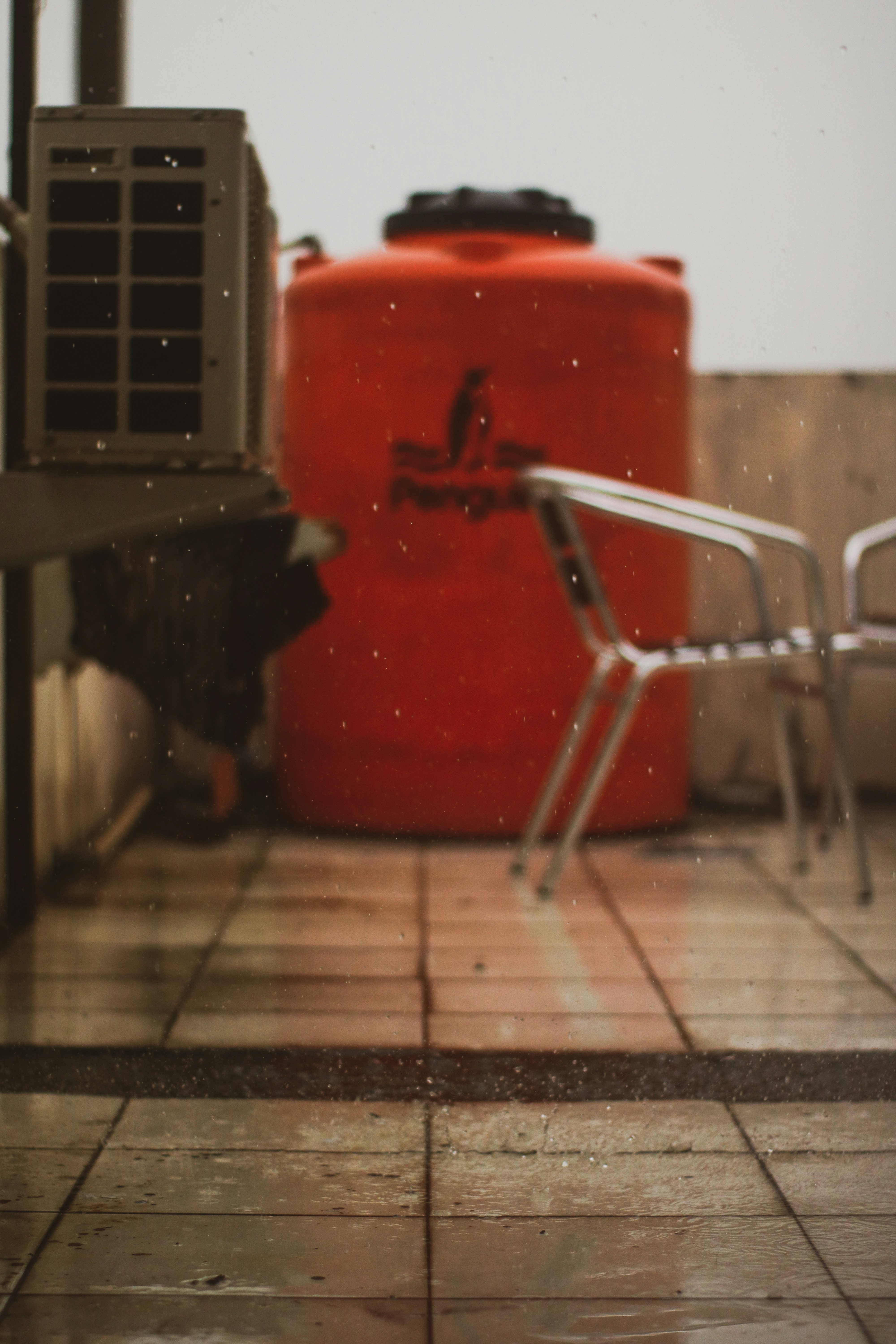 red plastic container on brown wooden table