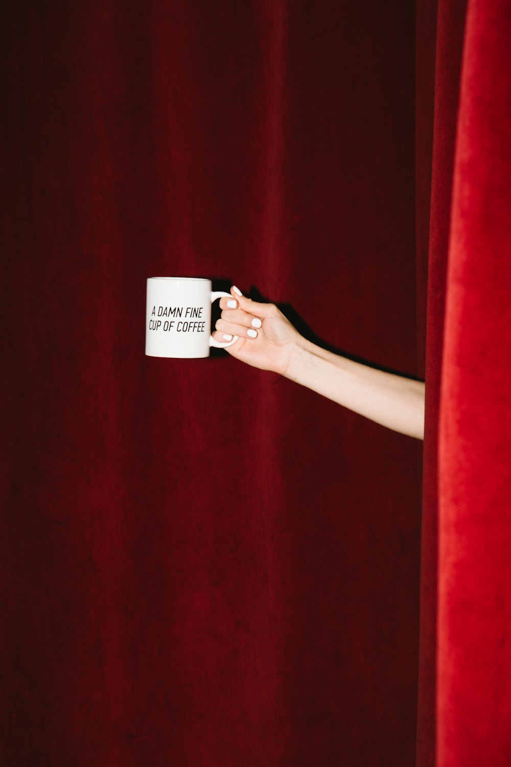 person holding white ceramic mug