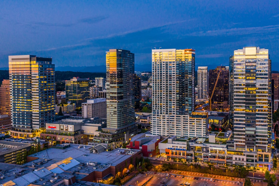 city skyline under blue sky during night time