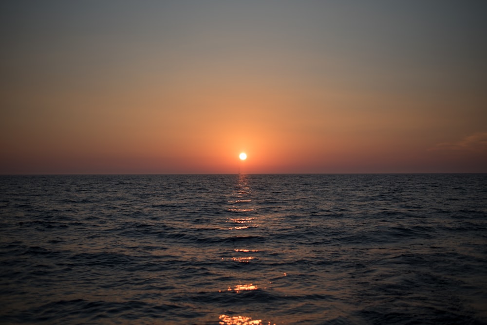 body of water during sunset