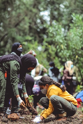 people in yellow jacket and black backpack