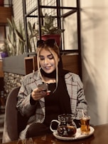 A happy customer using the tsbofficial wallet app on their phone in a cozy cafe setting.