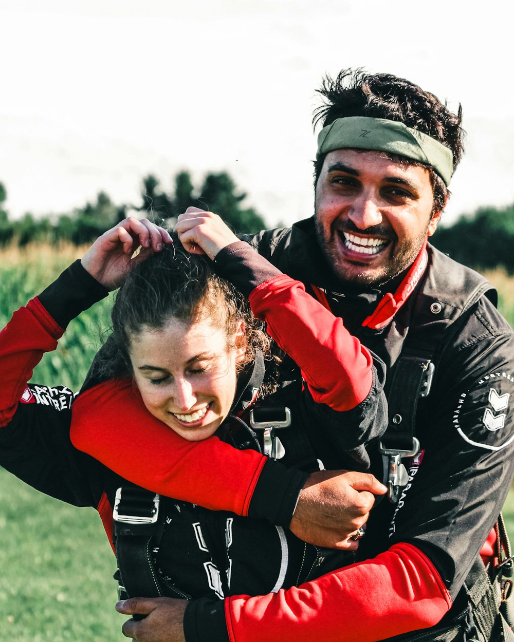 man in black and red long sleeve shirt carrying girl in red long sleeve shirt