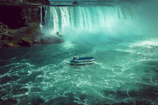 white and black boat on water falls in Fallsview Tourist Area Canada