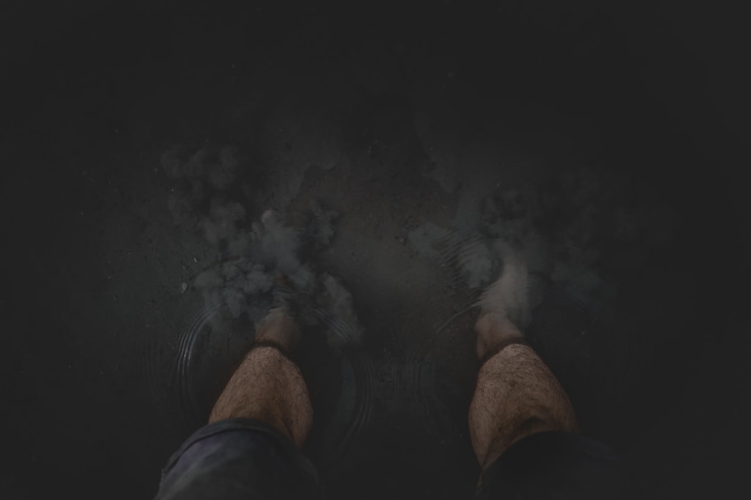 person in black shorts standing on black floor