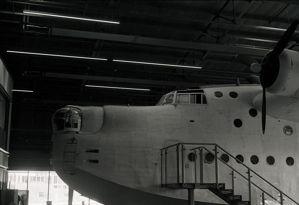 grayscale photo of airplane in a tunnel