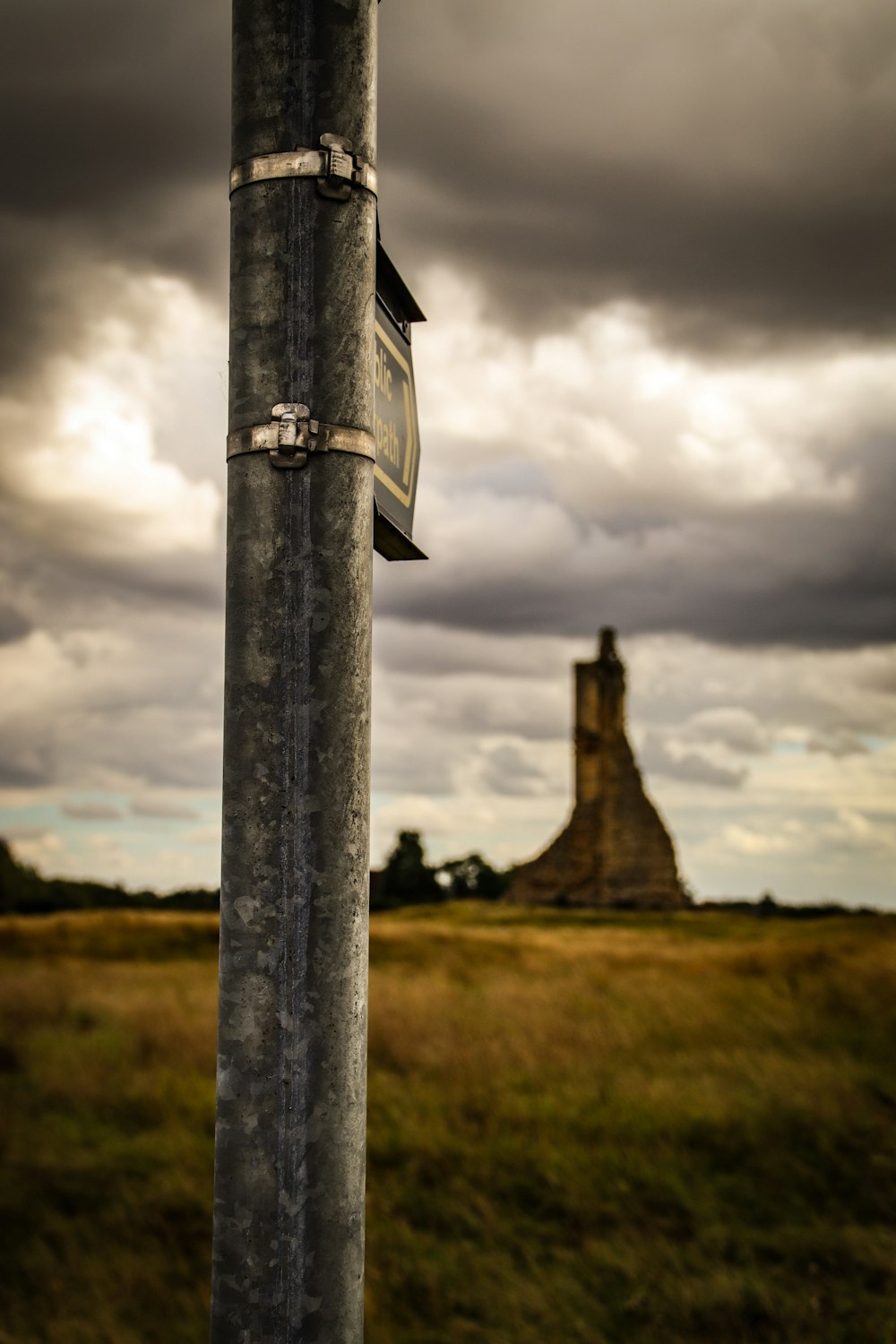 black and white cross under cloudy sky