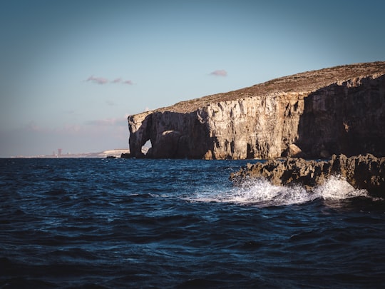 brown rock formation on sea during daytime in Gozo Malta