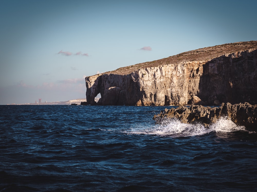 brown rock formation on sea during daytime