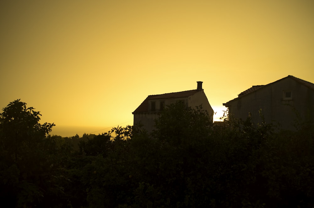 silhouette of house during sunset