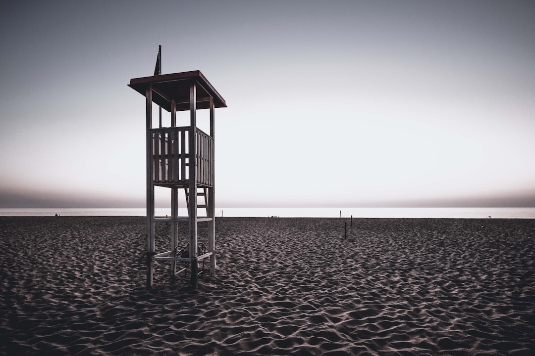 brown wooden lifeguard tower on beach during daytime