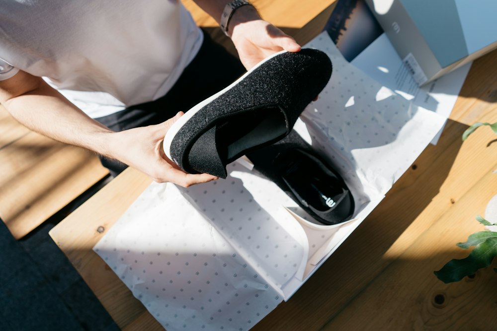 Person unpacking shoes wrapped in tissue paper