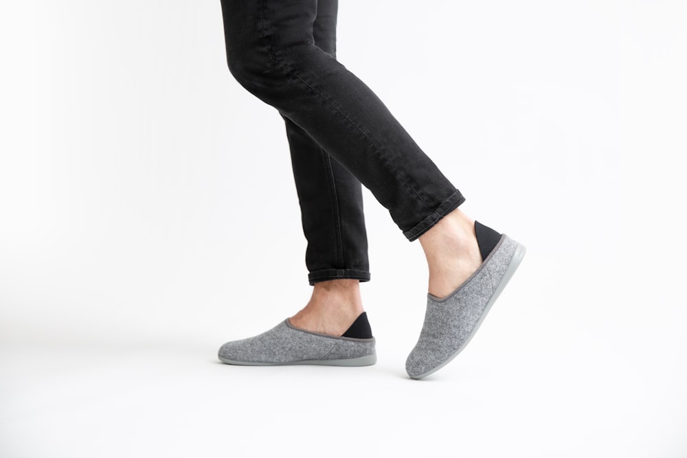 woman in black pants and gray flats