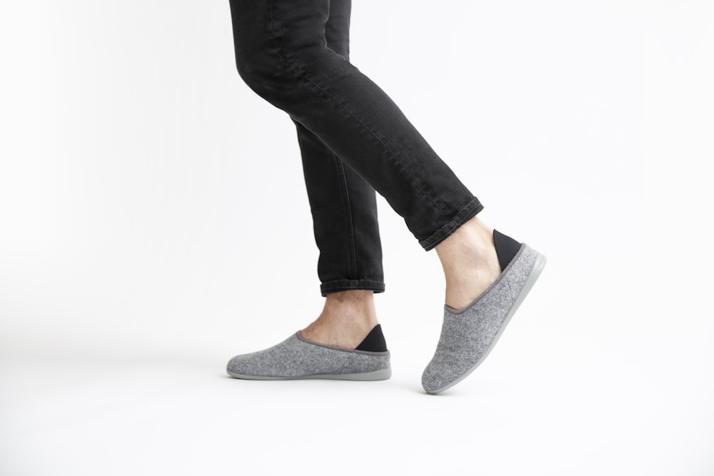 woman in black pants and gray flats