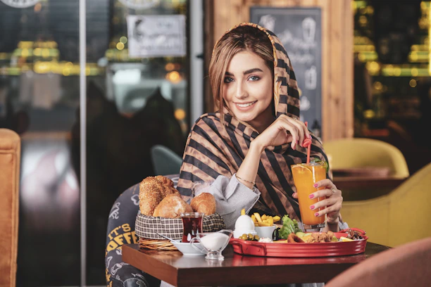 Warm vintage-toned photo of a happy customer enjoying a traditional Arabic dish at a wooden table.