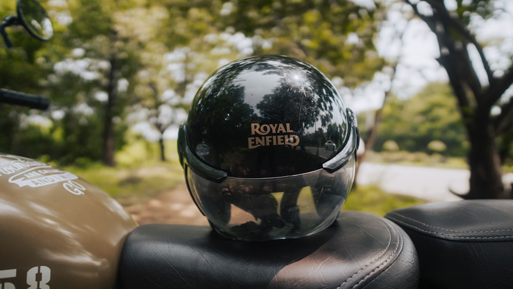 a motorcycle helmet sitting on the back of a motorcycle