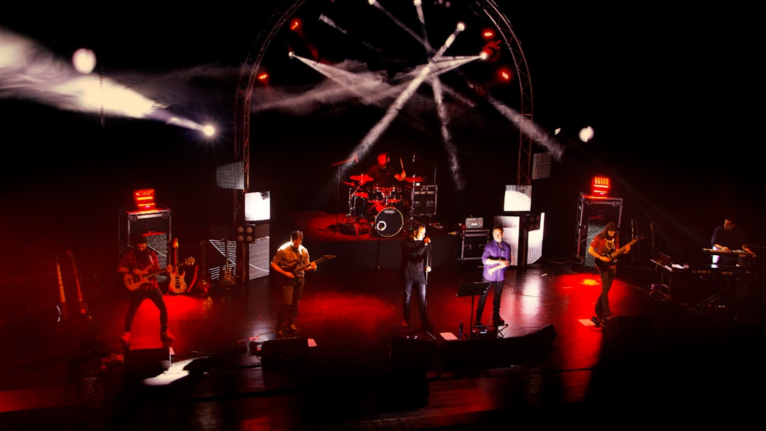 people standing on stage with lights