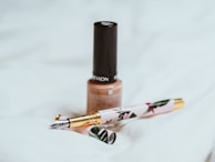 Stylish nail art session with warm beige and subtle golden highlights.