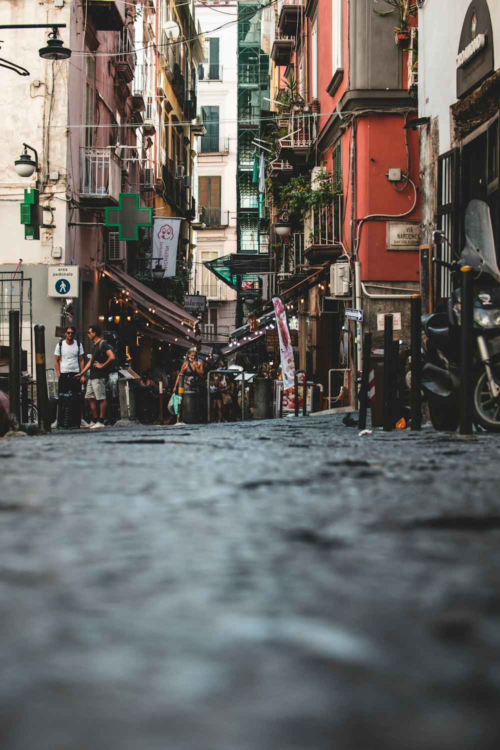 people walking on street between buildings during daytime