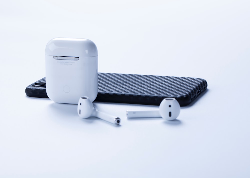 a pair of ear buds sitting on top of a case