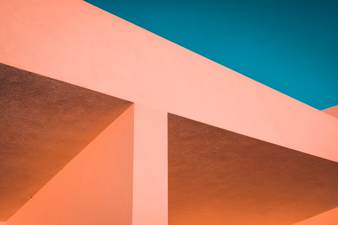 orange and white concrete building under blue sky during daytime