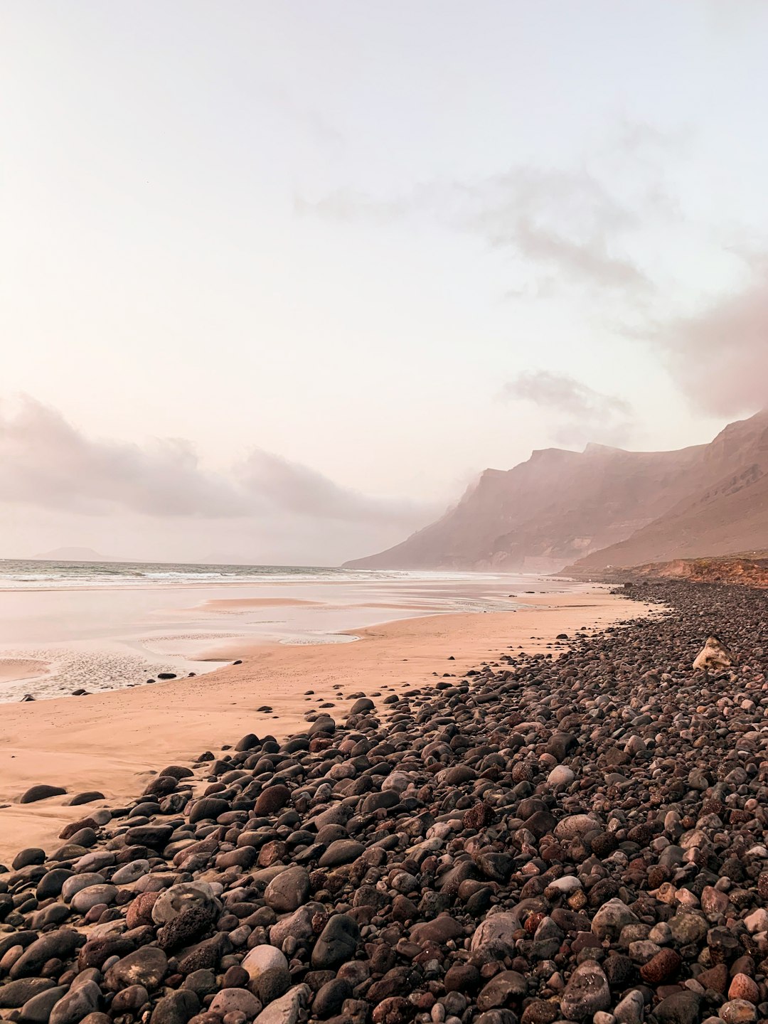 black stones on seashore during daytime