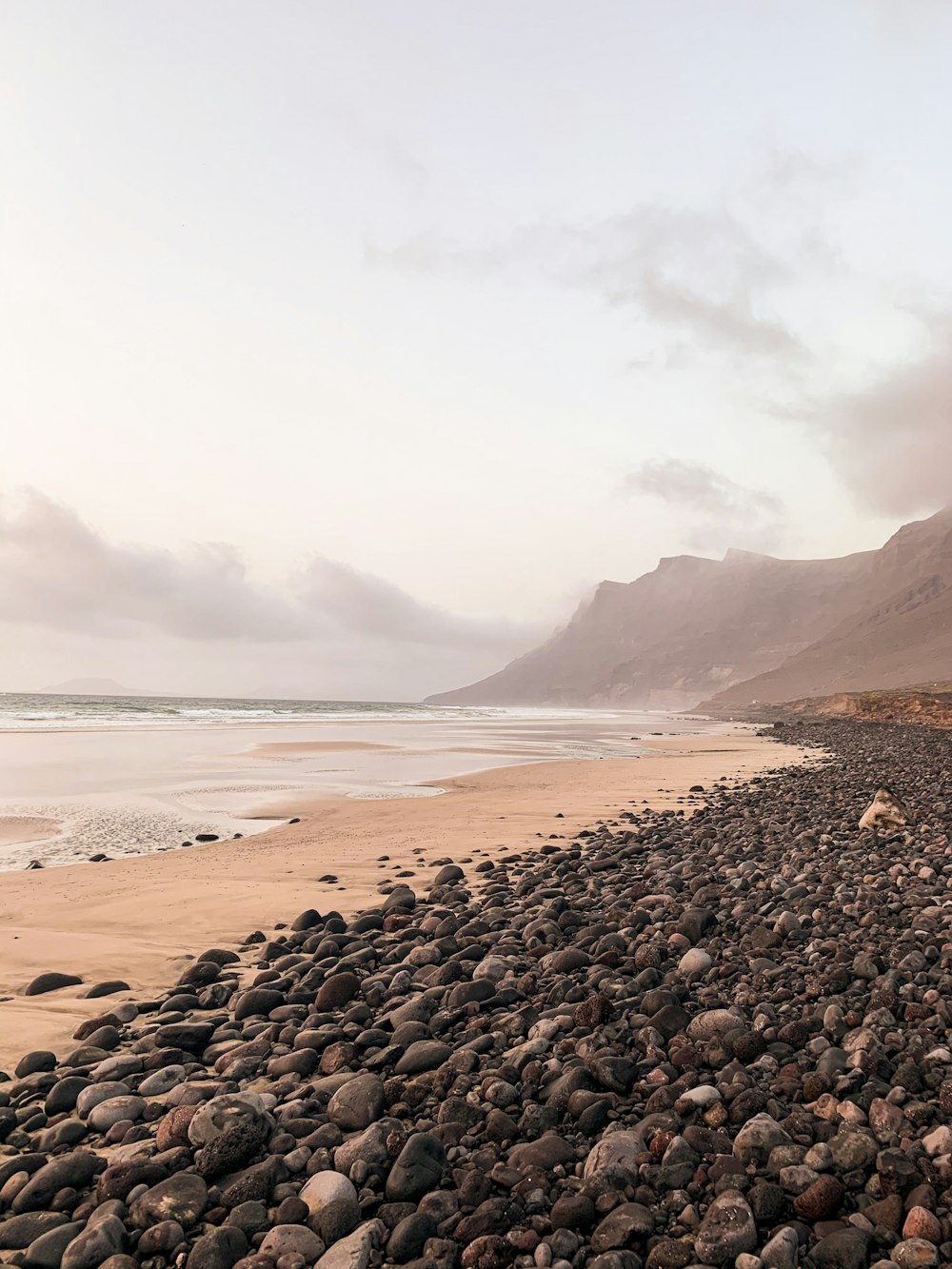 black stones on seashore during daytime