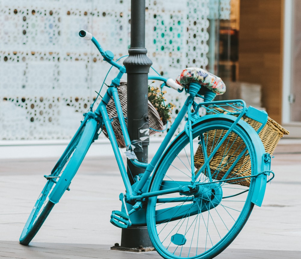 blue city bicycle with basket on top