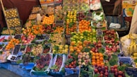 Colorful assortment of fresh fruits arranged on a market stall.