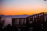Custom-built wooden deck overlooking a hillside garden at sunset.