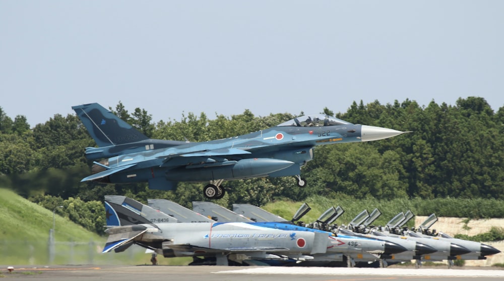 gray fighter plane on air during daytime