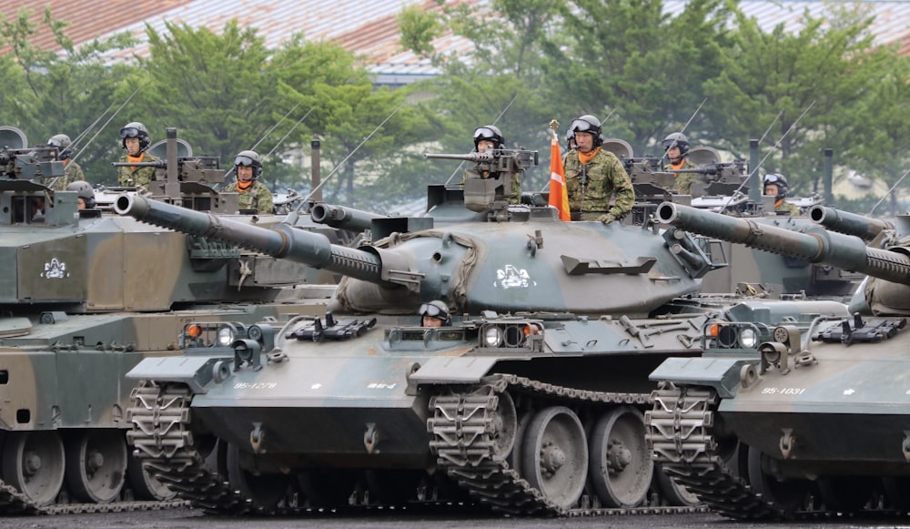 people riding battle tank during daytime