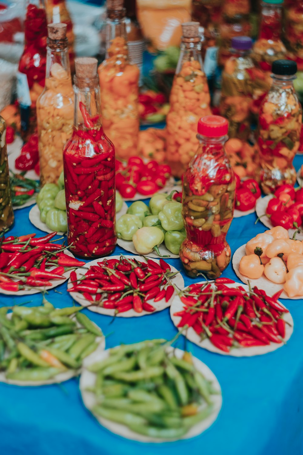 green and red vegetables on clear glass containers