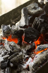Sculpture showing transformation of wood and charcoal under heat.
