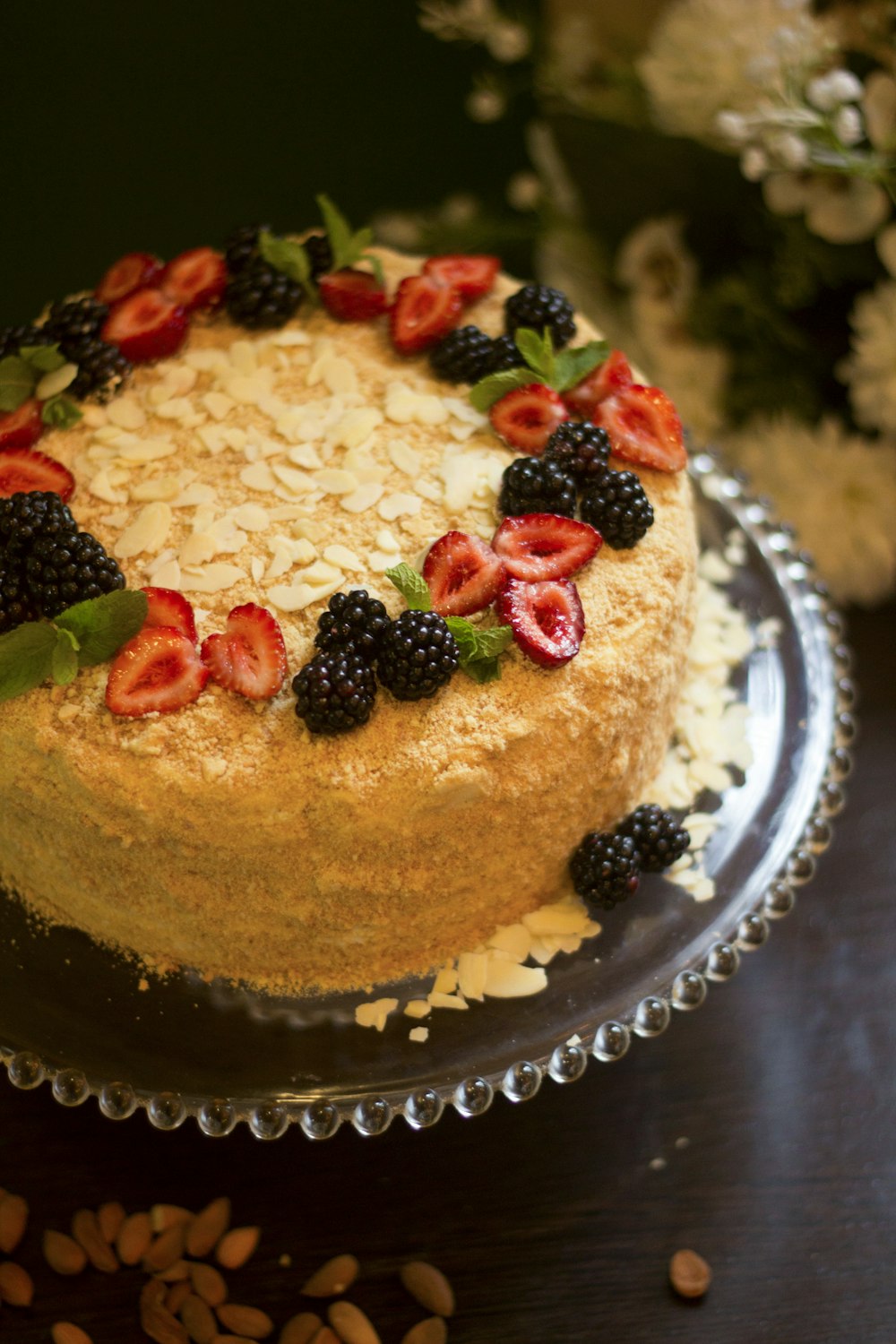 brown cake with white cream and strawberry on top